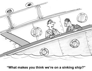 A cartoon of two men standing on a boat that is clearly sinking, with the caption "What makes you think we're on a sinking ship?"